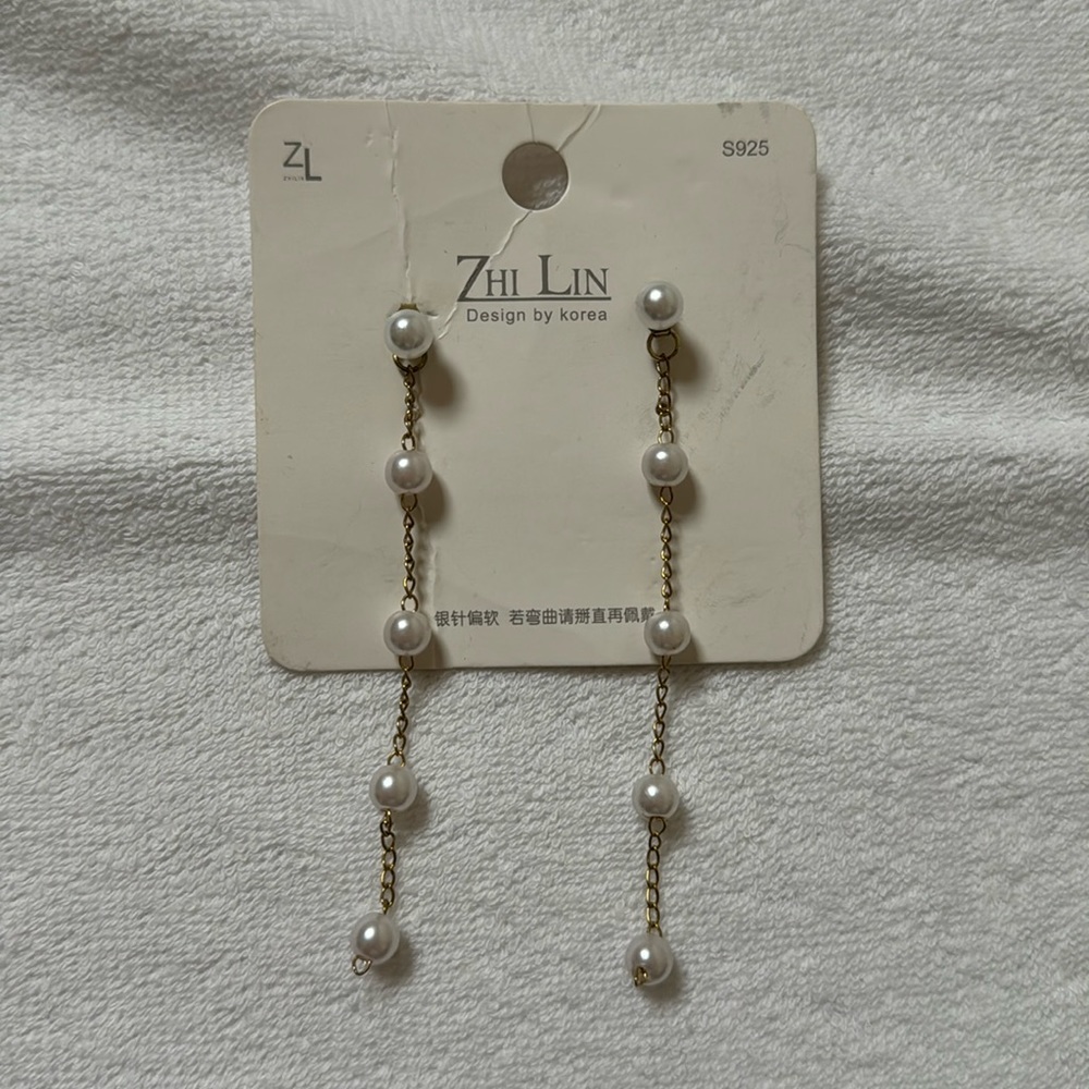 Faux pearl dangly earrings.